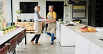 Elderly, couple and dancing in living room or happy with bonding, retirement and marriage in apartment. Senior, man or woman with dance for relationship, apron and romance with smile in house or home