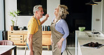 Senior, couple and dancing in living room or energy with bonding, retirement and marriage in apartment. Elderly, man or woman with dance for relationship, apron or romance with happy in house or home