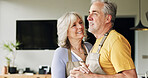 Elderly, couple and dancing in living room or happy with bonding, holding hands and marriage in house. Senior, man and woman with dance for relationship, apron and romance with smile in apartment