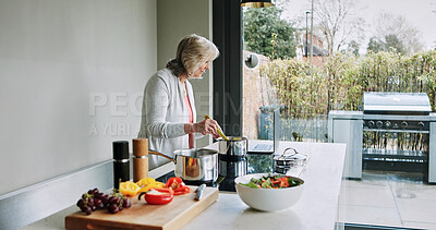 Buy stock photo Cooking, healthy food and mature woman in kitchen with laptop, recipe or reading a blog for dinner. Vegetarian, diet and person in home prepare vegetables, salad and nutrition in lunch or meal
