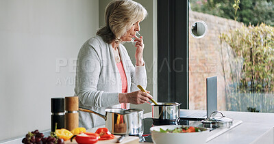 Buy stock photo Tasting, cooking and mature woman in kitchen with laptop, recipe or reading a healthy food blog for dinner. Vegetarian, diet and person in home prepare vegetables, salad or nutrition in lunch or meal