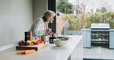 Buy stock photo Laptop, cooking and mature woman in kitchen with healthy food, recipe or reading a blog for dinner. Vegetarian, diet and person in home learning to prepare vegetables, salad or nutrition for meal