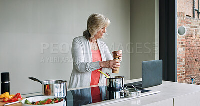 Buy stock photo Mature woman, cooking and laptop in kitchen with healthy food, recipe or reading a blog for dinner. Vegan, diet and person in home prepare vegetables, salad and nutrition with salt in lunch meal
