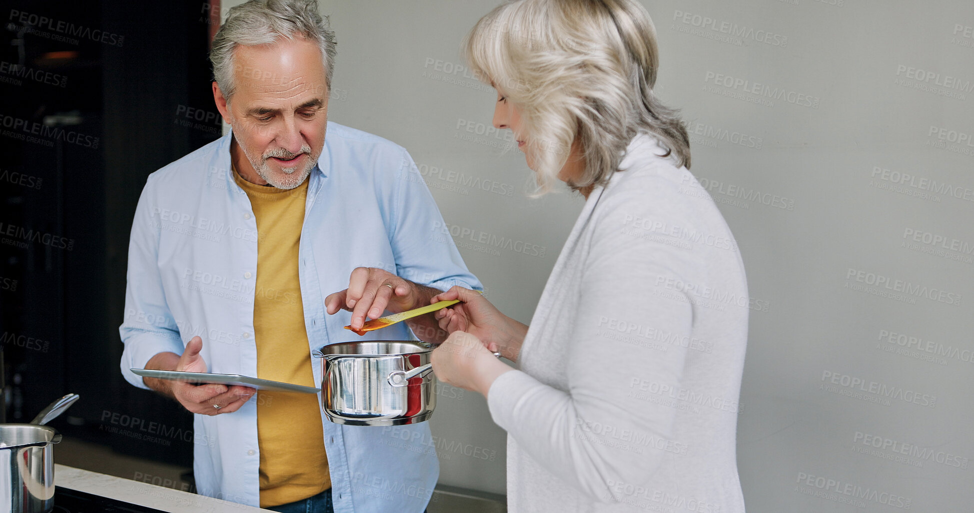 Buy stock photo Senior, couple and cooking in kitchen with taste or tablet for meal prep, recipe idea and digital menu with pot. Elderly, man and woman with technology at home for healthy food and diet in house