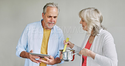 Buy stock photo Senior, couple and cooking in kitchen with tablet for meal prep, recipe idea and digital menu with support. Elderly, man or woman with technology at home for healthy food ingredients or diet planning