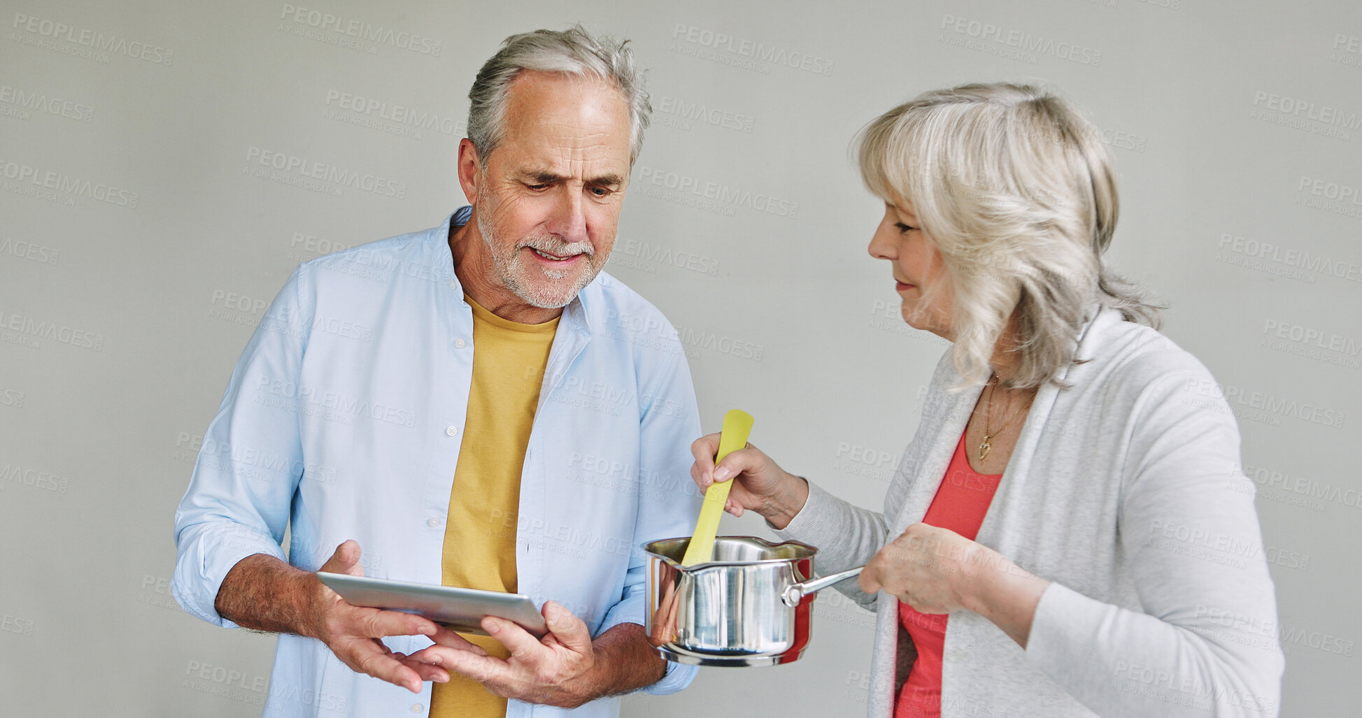 Buy stock photo Senior, couple and cooking in kitchen with tablet for meal prep, recipe idea and digital menu with support. Elderly, man or woman with technology at home for healthy food ingredients or diet planning