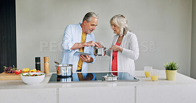 Buy stock photo Senior, couple and cooking in kitchen with tablet for meal prep, recipe idea and digital menu with help. Elderly, man and woman with technology at home for healthy food ingredients and diet planning