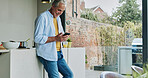 Senior man in kitchen, relax with phone and cooking breakfast, calm morning and checking social media. Home, online recipe and  elderly person with smartphone, smile and reading email on mobile app.
