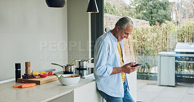 Buy stock photo Senior man in kitchen with smile, phone and cooking breakfast in calm morning with social media. Home, online recipe and elderly person with smartphone, networking and reading email on mobile app.