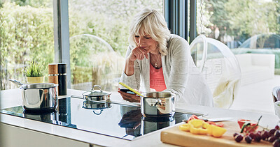 Buy stock photo Old woman in kitchen with phone, cooking and thinking of breakfast with social media search in house. Home, online communication and elderly person with smartphone, networking and email on mobile app