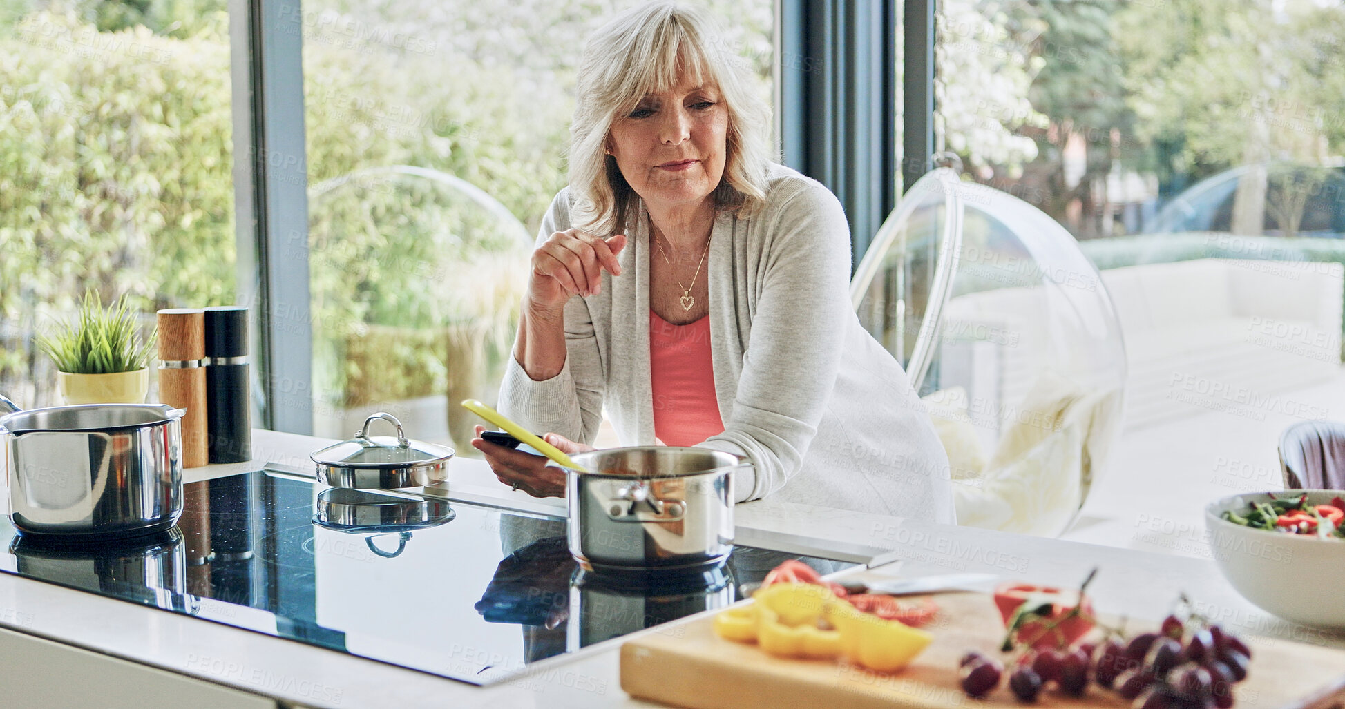 Buy stock photo Old woman in kitchen with phone, breakfast and fruit for salad with social media cooking in house. Home, online communication and elderly person with smartphone, search and healthy food on mobile app