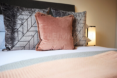 Buy stock photo Pillows, fabric and interior design of bedroom with duvet, comforter or patterns for hotel accommodation. Closeup of empty room, house or apartment at resort with stylish cushion, linen or home decor