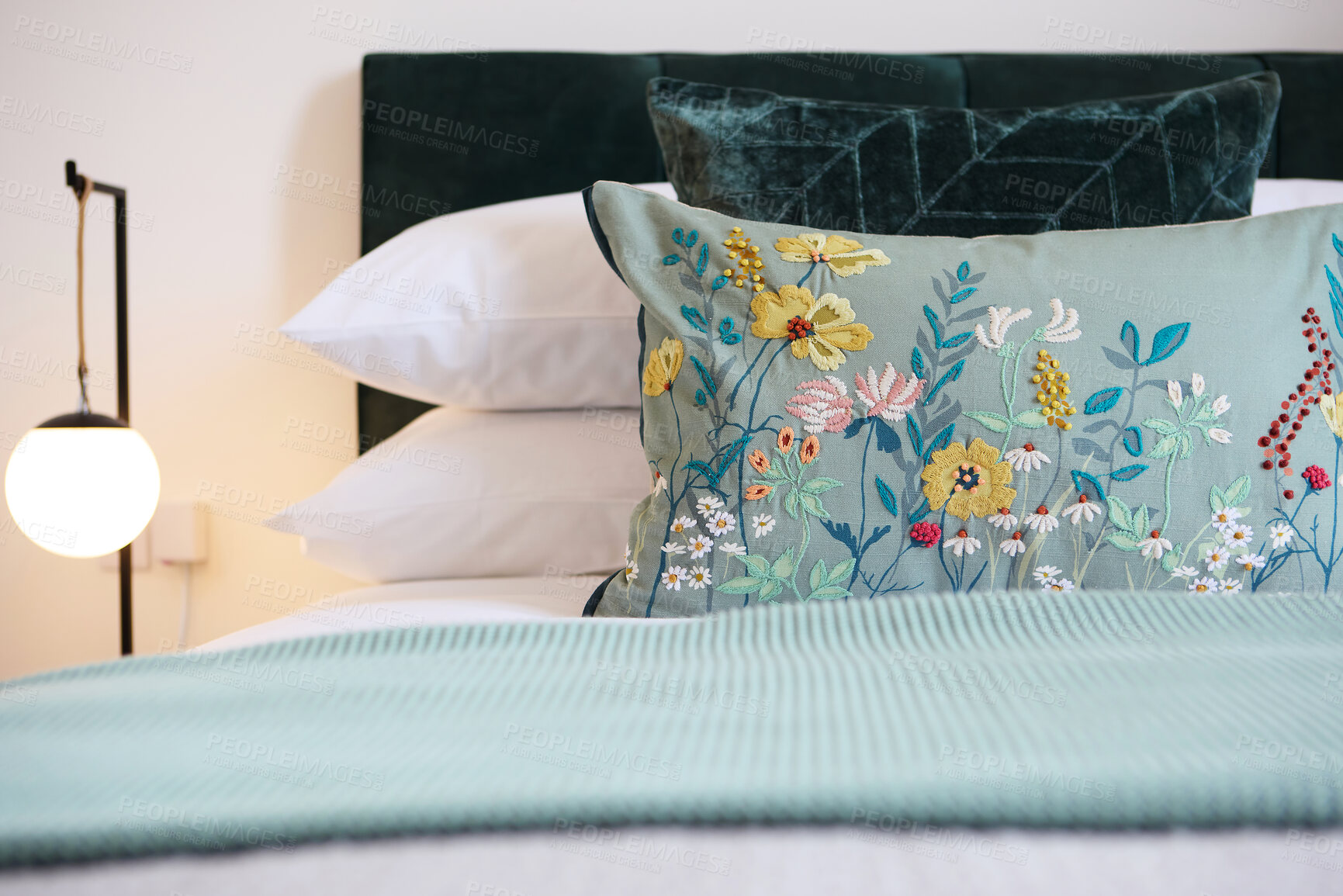 Buy stock photo Bed, pillow with floral design and hotel room for hospitality, accommodation for comfort with furniture and decor. Bedroom, property or house for vacation, getaway or luxury resort with closeup