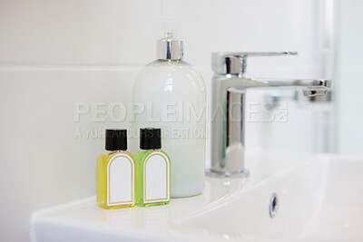 Buy stock photo Bathroom, soap and dispenser at hotel for hygiene, accommodation or cleaning equipment at resort. Closeup of interior, sink or tap with containers, bottle or domestic decor for product placement