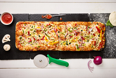Top view, dough and pizza or fast food preparation for dinner, baking process and ingredients on kitchen table. Patisserie, napoli sauce and onion with mushroom in restaurant or cafe from above
