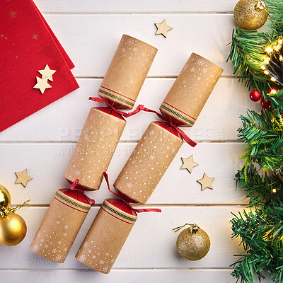 Buy stock photo Christmas, cracker and decorations table from above with stars, tinsel trimming and festive party favors. Xmas tree, deco and lights for celebration, holiday baubles and poppers with ornaments.