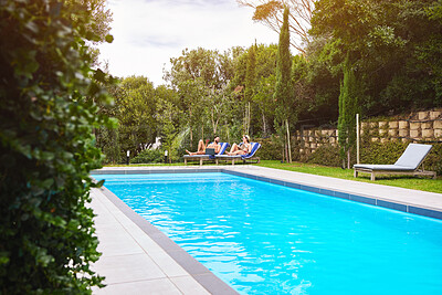 Buy stock photo Swimming pool, people and chairs outdoor for relax, travel and summer at luxury hotel as holiday. Water, couple and sun loungers for wellness, hospitality and vacation at resort in Bali with freedom