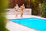 Happy couple, pool and holding hands for jump, fun and support in relationship at resort. Man, woman and freedom on vacation for wellbeing, love and ready for dive at water on weekend trip to villa