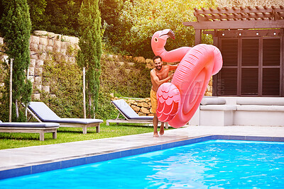 Buy stock photo Man, flamingo and fun at pool on vacation, luxury and enjoy the summer at resort. Inflatable toy, male person and ready for jump at water with excitement, holiday and energy on weekend trip to villa