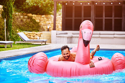 Buy stock photo Portrait, relax and man on inflatable in swimming pool for summer vacation, weekend break or getaway at resort. Outdoor, water and person on flamingo float for sunbathing, comfortable or happiness