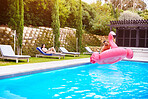 Man, inflatable and fun on holiday in pool for wellness, freedom at resort for comic adventure. Male person, crazy and air toy on vacation at hotel for travel, water and summer joy in Costa Rica