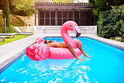 Buy stock photo Male person, relax and flamingo in swimming pool for holiday, summer and sunshine for vacation. Man, sleeping and inflatable bird in water for travel, calm or zen and float for weekend trip to Miami