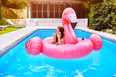 Buy stock photo Woman, memory and relax in pool on flamingo for summer, smile and sunshine for vacation. Female person, thinking and inflatable bird in water for calm and zen with float for weekend trip to Miami
