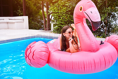 Buy stock photo Water, relax and woman on inflatable in swimming pool for summer vacation, weekend break or getaway at resort. Smile, outdoor and happy person on flamingo float for sunbathing, comfortable or holiday