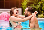 Happy, couple and hug with love in swimming pool outdoor for bonding together, relax and water at summer house. Smile, man and woman with embrace for romance, care and support by poolside on break