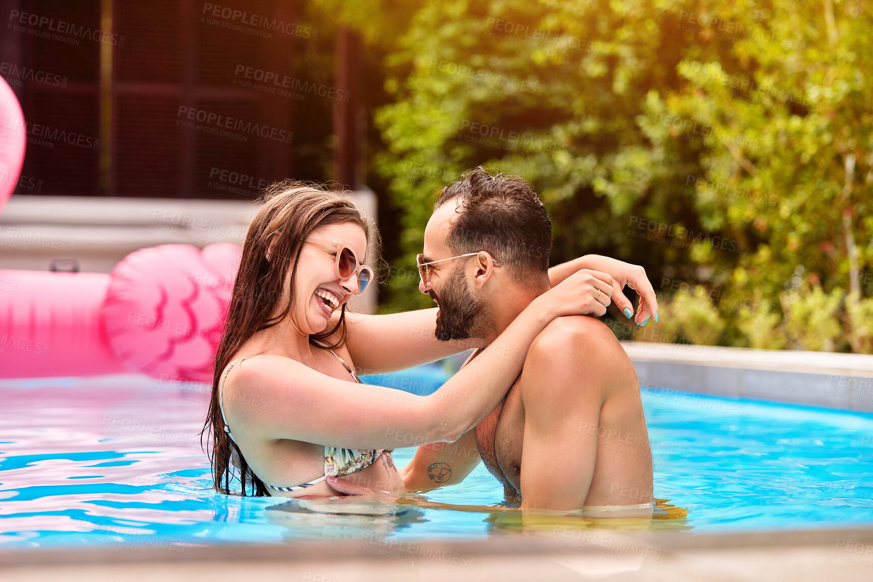 Buy stock photo Couple, happy and hug with love in swimming pool outdoor for bonding together, relax and water at summer house. Smile, man and woman with embrace for romance, care and support by poolside on break