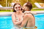 Couple, laugh and hug with love in swimming pool outdoor for bonding together, relax and water at summer house. Happy, man and woman with embrace for romance, care and support by poolside on break