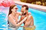 Laugh, swimming pool and happy couple together on holiday, vacation or travel outdoor. Swimmer, funny man and woman in water to relax on summer date for love, embrace or romantic getaway in Australia
