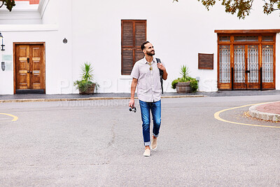 Buy stock photo Walking, exploring and man on vacation in city for sightseeing with backpack and camera for journey. Travel, adventure and person commuting in street by weekend trip accommodation in town in England.