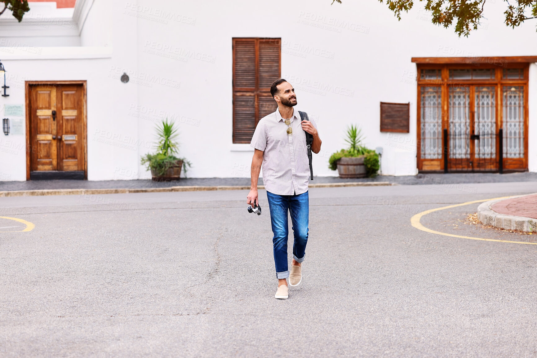 Buy stock photo Walking, exploring and man on vacation in city for sightseeing with backpack and camera for journey. Travel, adventure and person commuting in street by weekend trip accommodation in town in England.