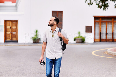 Buy stock photo Walking, holiday and man on vacation in city for sightseeing with backpack and camera for journey. Exploring, adventure and person commuting in street by weekend trip accommodation in town in England