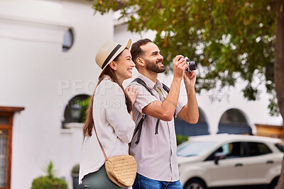 Buy stock photo Happy, couple and tourist with photography outdoor for adventure, sightseeing and together for holiday. Man, woman and camera for pictures on tour, cultural experience and travel documentation.