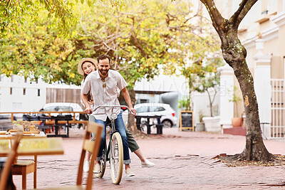 Buy stock photo Happy couple, bicycle and ride with date in city for fun bonding, travel or outdoor holiday. Young man, woman or tourists enjoying day of cycling, leisure or activity together on bike in urban town