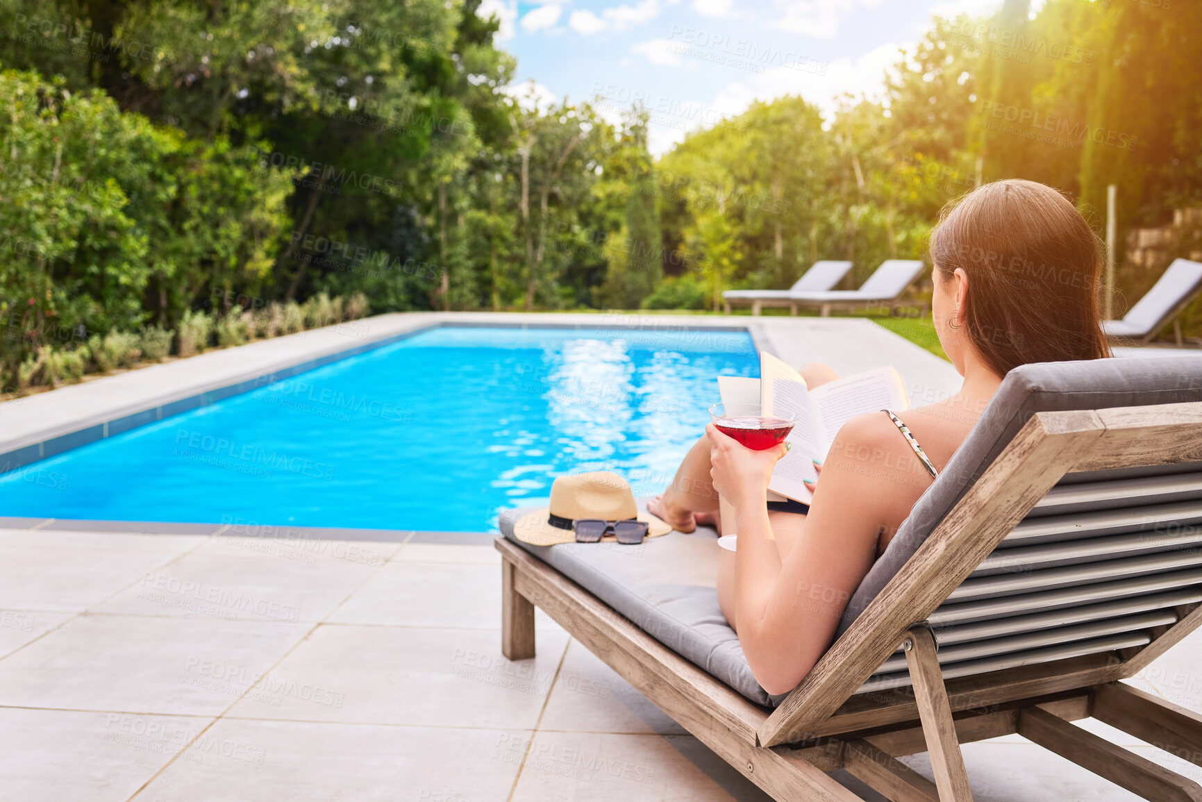 Buy stock photo Reading, woman and cocktail at hotel pool for fantasy, relax and freedom for luxury holiday. Water, glass and female person at resort for summer, travel and calm for vacation or hospitality in Miami