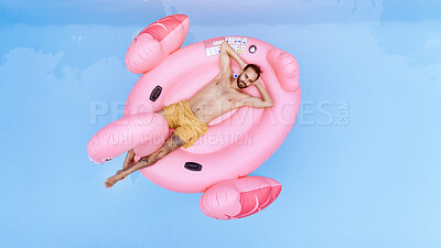 Buy stock photo Holiday, relax and man on inflatable in swimming pool for summer vacation, weekend break or getaway at resort. Aerial view, water and person on flamingo float for sunbathing, comfortable or peace