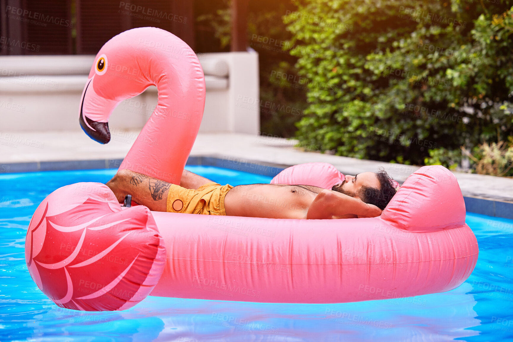 Buy stock photo Man, relax and flamingo in swimming pool on vacation for tropical escape, sunshine and chill mode for sunbathing. Male person, floating and summer holiday for leisure, weekend trip and outdoor.