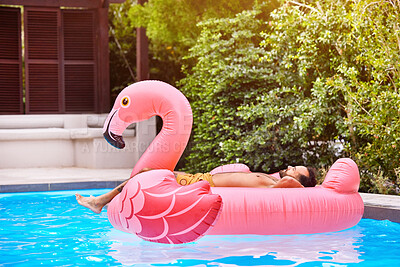 Buy stock photo Man, relax and flamingo in swimming pool for holiday, summer and sunshine for vacation. Male person, sleeping and inflatable bird in water for travel, calm or zen and float for weekend trip to Miami