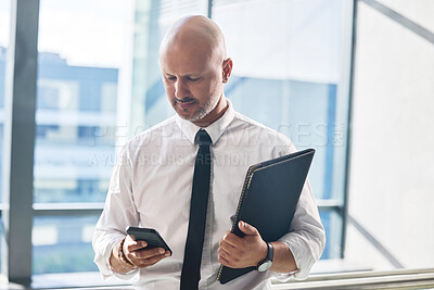 Buy stock photo Cellphone, man and networking in office for business meeting, report and email or review. Professional person, lawyer and documents or folder and technology for schedule, internet and online news app