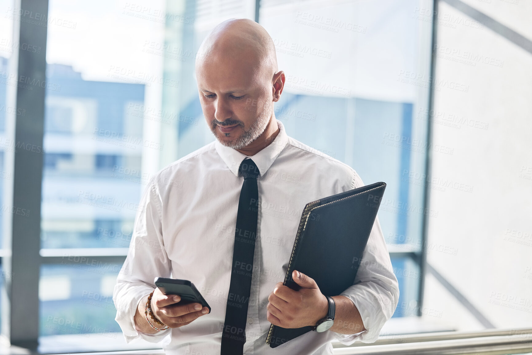 Buy stock photo Cellphone, man and networking in office for business meeting, report and email or review. Professional person, lawyer and documents or folder and technology for schedule, internet and online news app