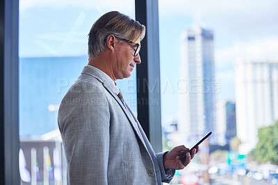 Buy stock photo Mature man, business and smartphone in office building for communication, networking and check schedule. Director, corporate and phone in workplace for investment, website or booking of travel flight