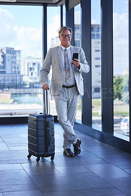 Buy stock photo Mature man, travel and mobile in airport for communication, networking and check schedule or agenda. Director, corporate and phone in building for investment, trading and booking of taxi or flight