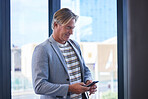 Phone, trip and mature businessman in airport on mobile app for flight check in on work travel. Cellphone, research and male finance executive booking hotel accommodation online for corporate journey
