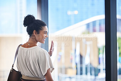 Buy stock photo Airport, smile and wave with business woman at window in terminal for departure, travel or trip. Flight, glass and goodbye with happy employee as passenger at boarding gate for farewell or leaving