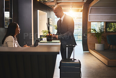 Buy stock photo Check in, reception and mature man with luggage in hotel for business meeting, hospitality or travel. Service, concierge woman and person with suitcase for welcome, vacation or sales convention