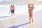 Water, kids and parents on walking on beach with fun, bonding and outdoor holiday adventure together. Mom, dad and children on summer vacation with ocean, waves and happy family on tropical island