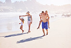Ocean, kids and parents on walking on holiday with fun, bonding and outdoor travel adventure together. Mom, dad and children on summer vacation with beach, water and happy family on tropical island